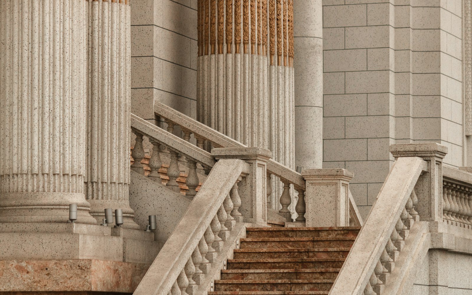 A stone staircase and classical columns at the entrance of a public building