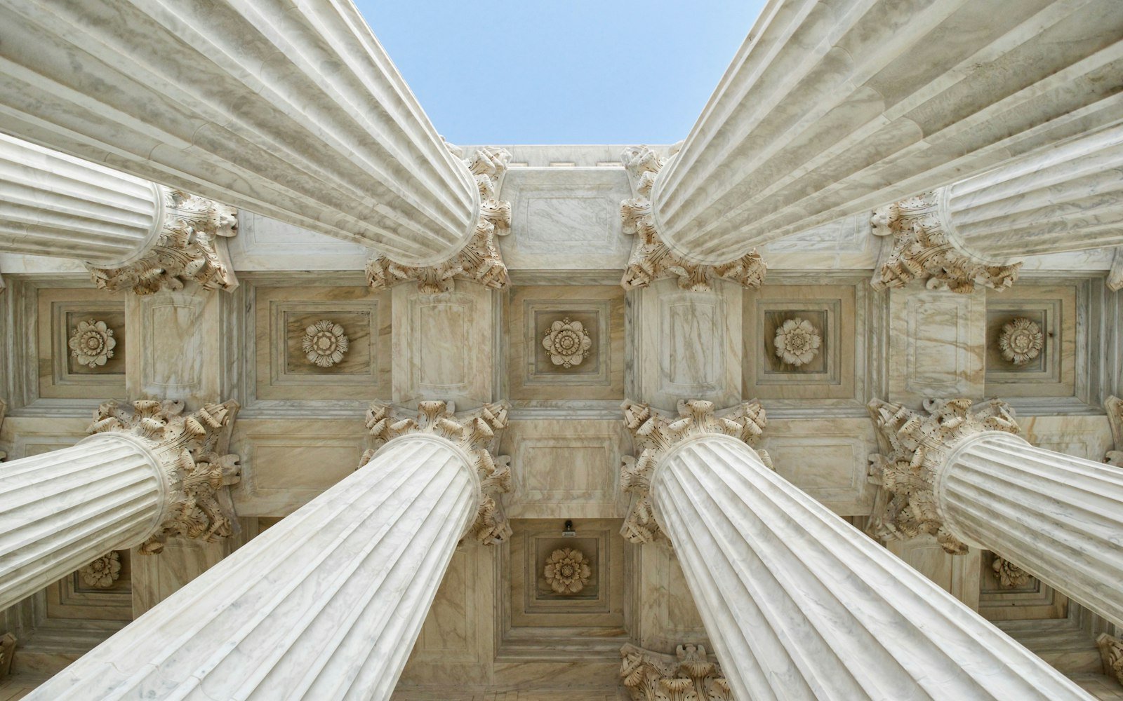 Stone columns and carved ceiling seen from below