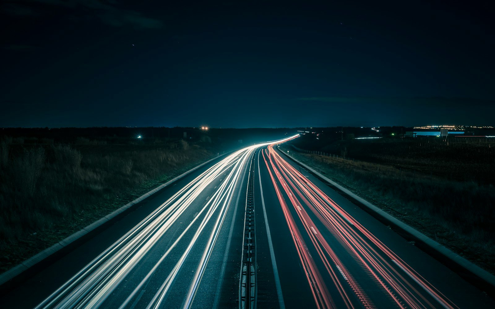 Light trails from traffic on a highway at night