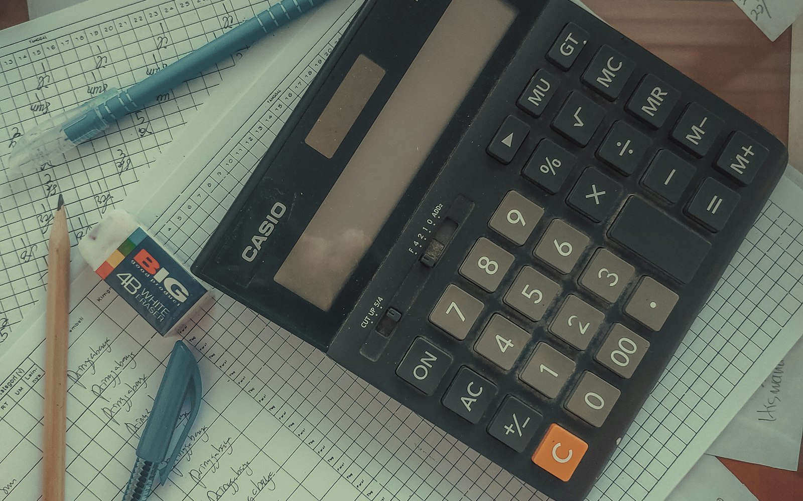 Calculator resting on financial papers