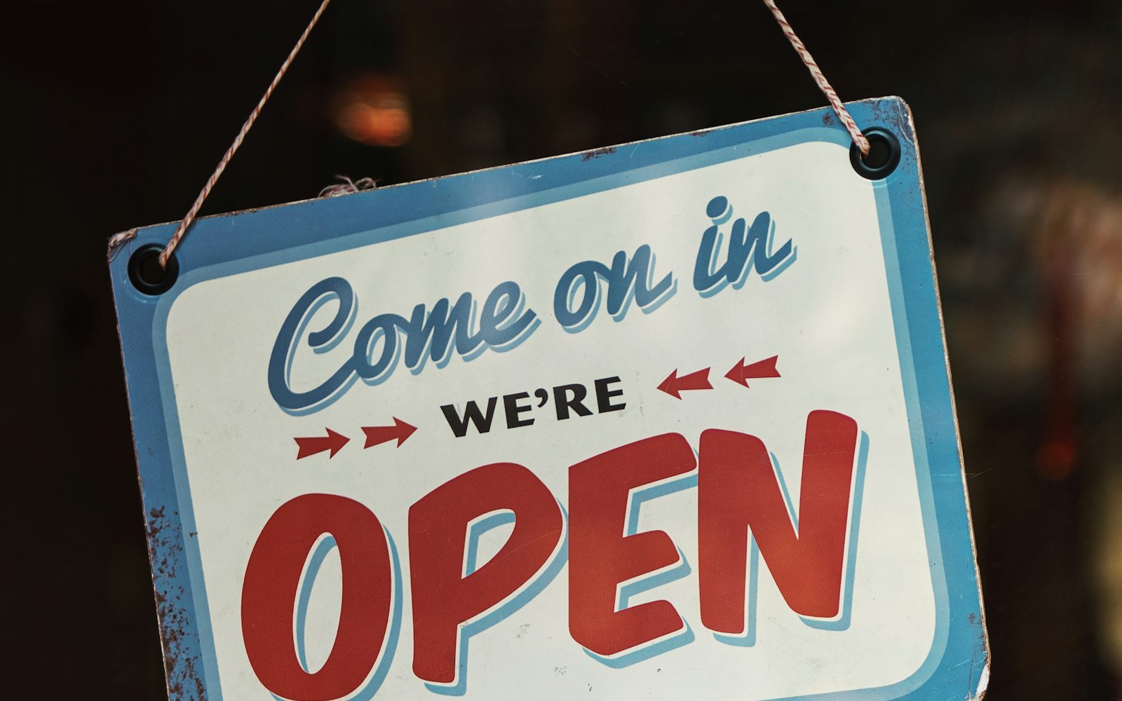 A shop sign reading “Come on in, we’re open”