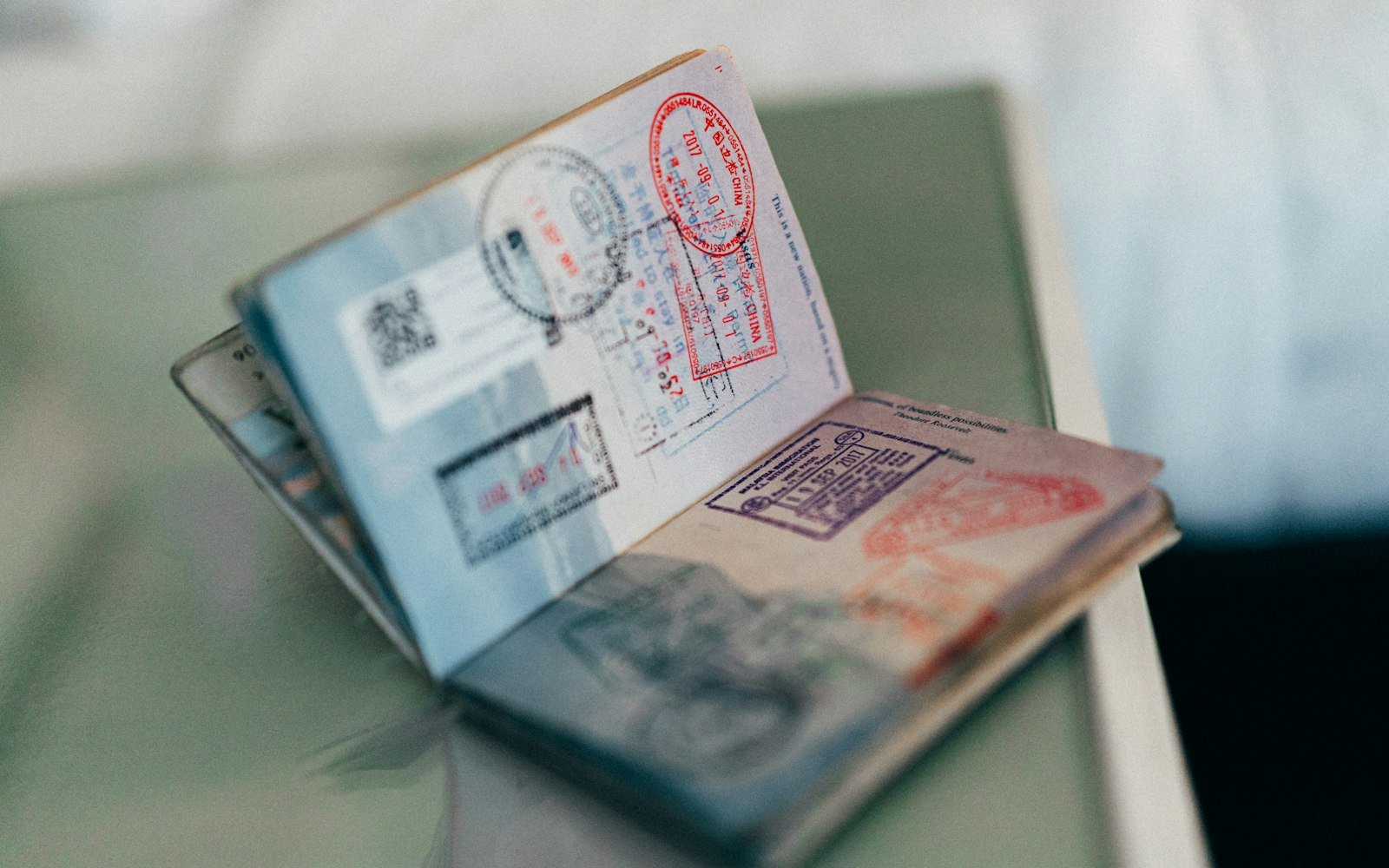 An open passport with coloured entry stamps