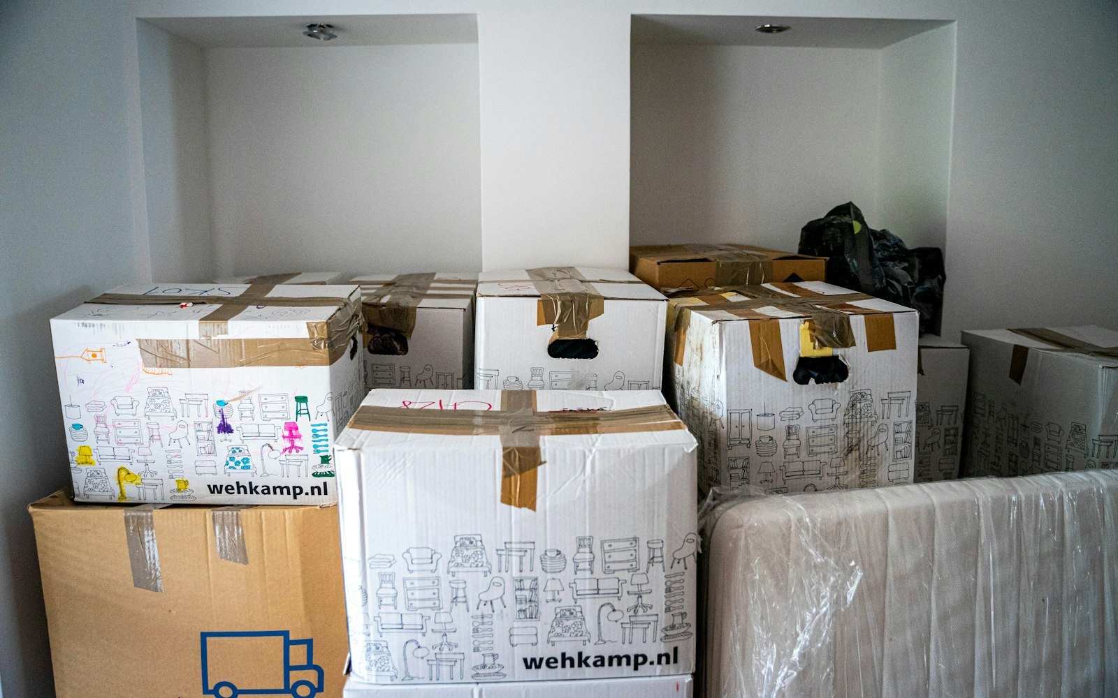 Moving boxes stacked in an empty room