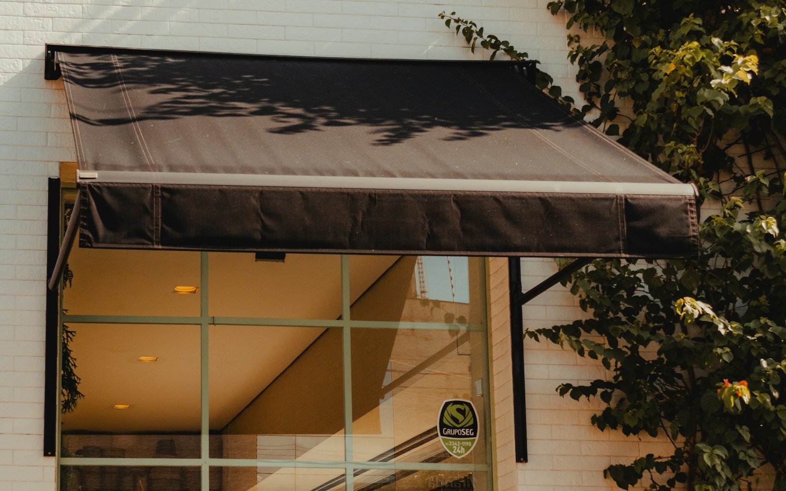 A row of street-level storefronts with awnings