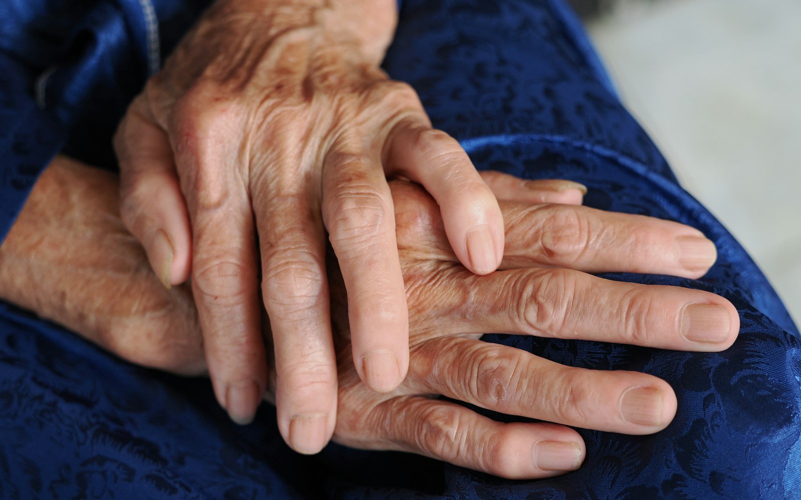 Older person's hands resting together
