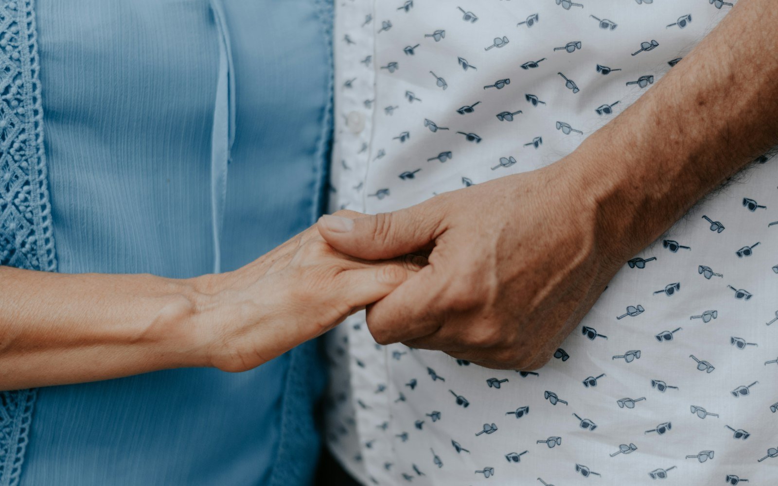 Two people holding hands