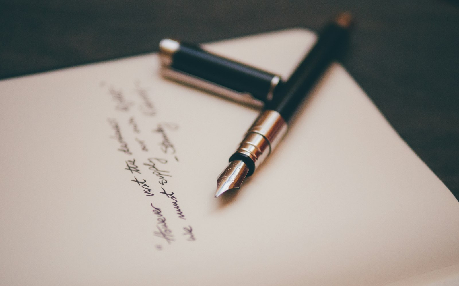 Fountain pen resting on a handwritten letter