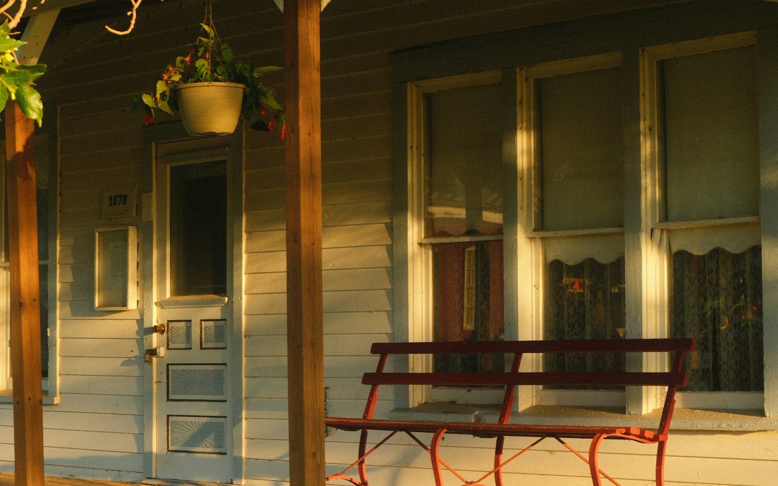 Bench on a sunlit house porch