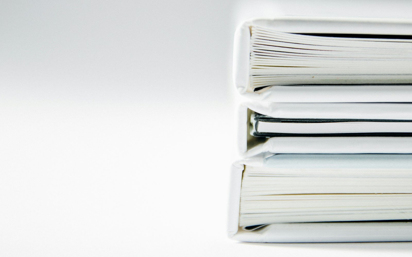 Stack of thick folders of paper